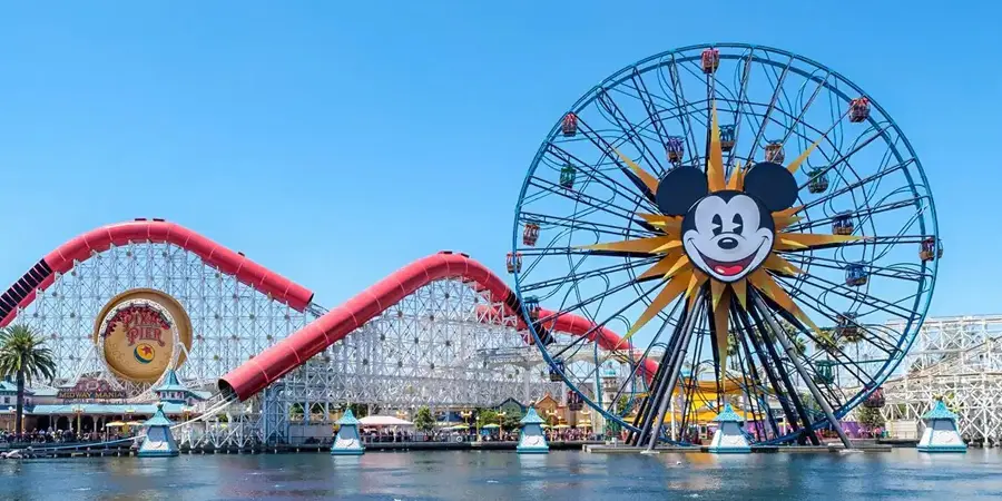 A giant Mickey Mouse face on a Ferris Wheel, with a roller coaster in the background, at Disney California Adventure (Disneyland Resort)