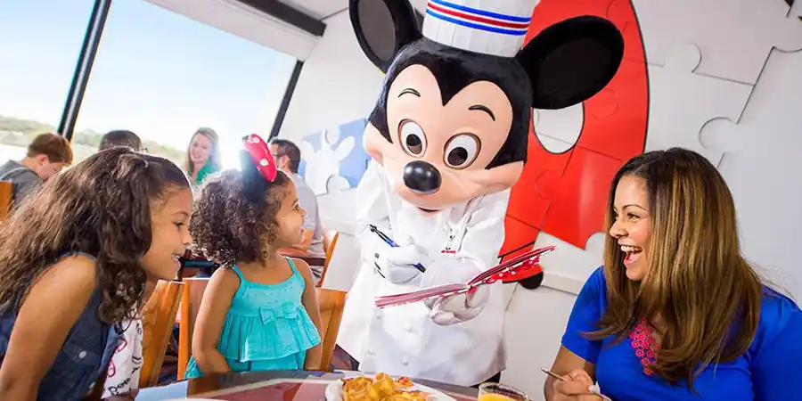Chef Mickey Mouse greets guests at their breakfast table